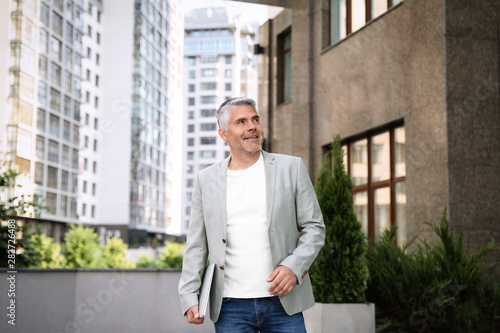 Wallpaper Mural Portrait of handsome mature man with laptop in city center Torontodigital.ca