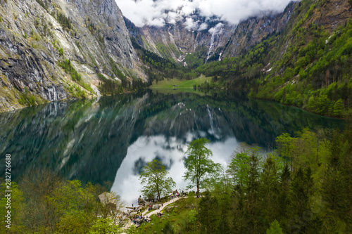 Scenic mountain panorama with green meadows and idyllic turquoise Lake Oberer