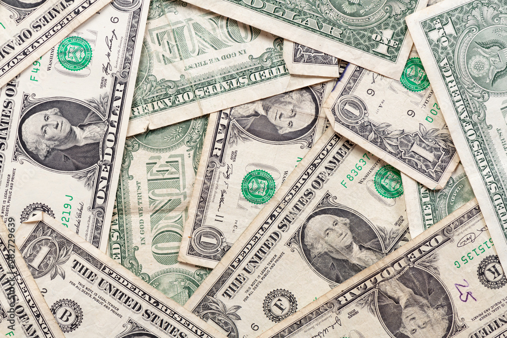Many overlapping one dollar bills close up macro background Many overlapping one dollar bills close up macro background