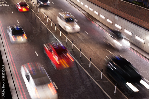 Elevated view timelapse of traffic going through an underpass at night themes of rush hour transportation traffic