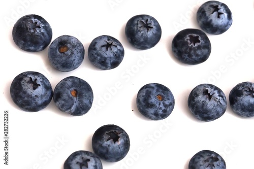 In selective focus a group of fresh blueberries on white isolated background