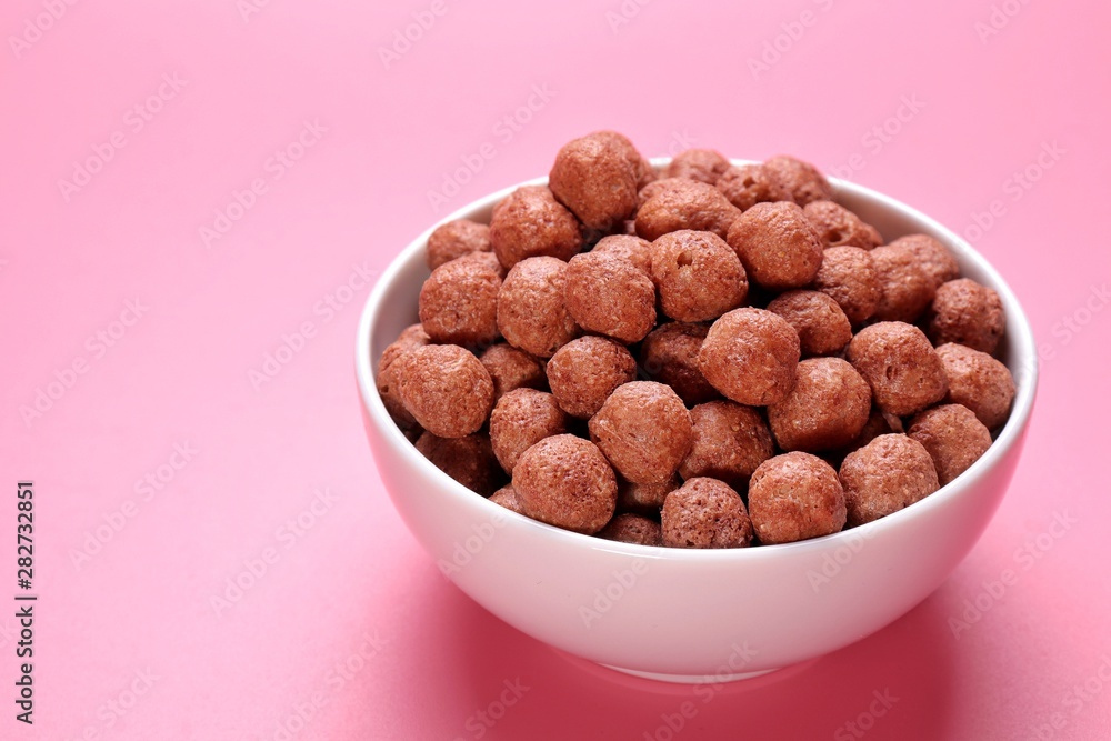 Chocolate breakfast in bowl isolated on pink background Chocolate breakfast in bowl isolated on pink background