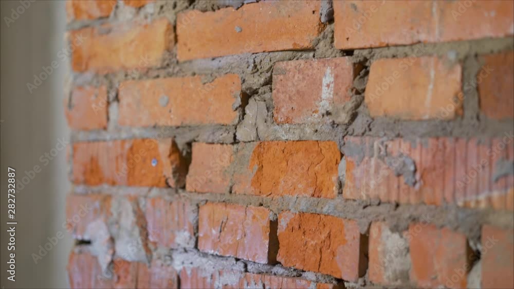 wall of bright old red brick as beautiful loft-style background for modern interior design and exterior of industrial premises, apartments and houses. Old brickwork in the apartment wall of bright old red brick as beautiful loft-style background for modern interior design and exterior of industrial premises, apartments and houses. Old brickwork in the apartment