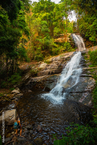 Tourist admire Huai Sai Luang waterfall in Doi Inthanon National Park near Chiang Mai Thailand