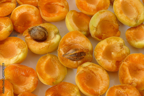 pitted apricots, dried in the sun in trays, apricot drying on the balcony,