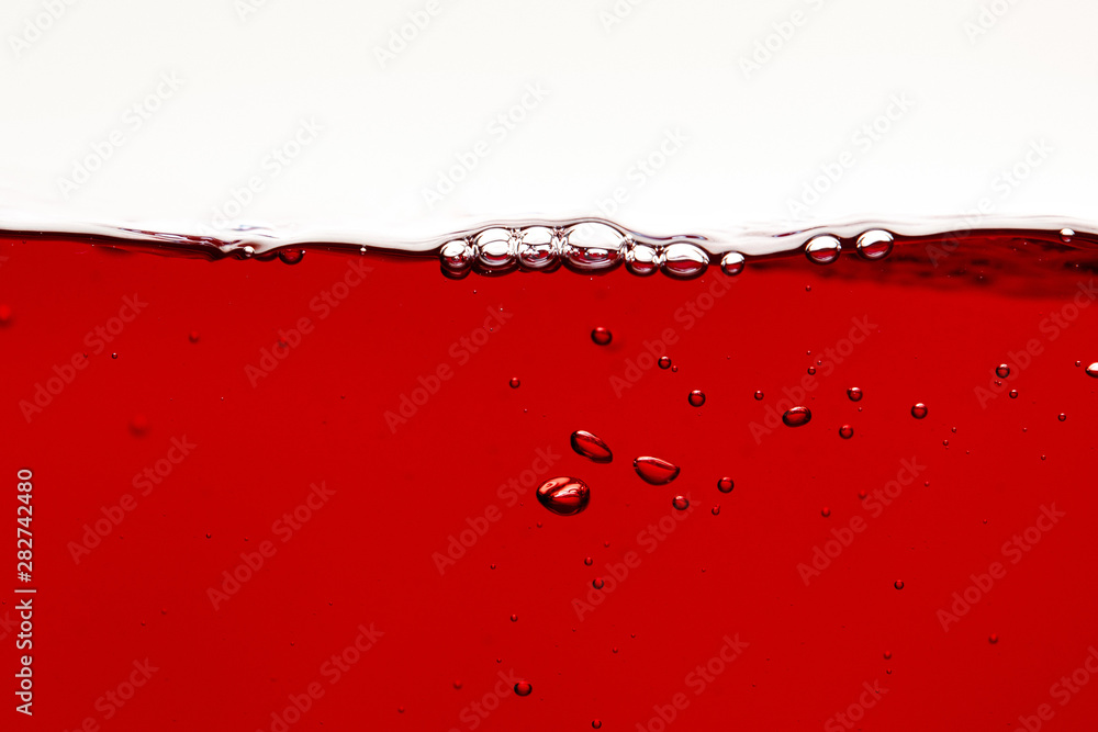 red bright liquid with bubbles on surface isolated on white - obrazy, fototapety, plakaty 