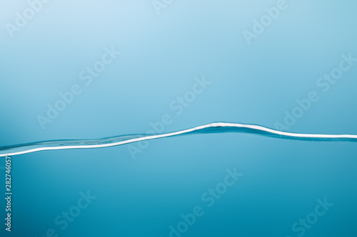 smooth calm transparent pure water on blue background