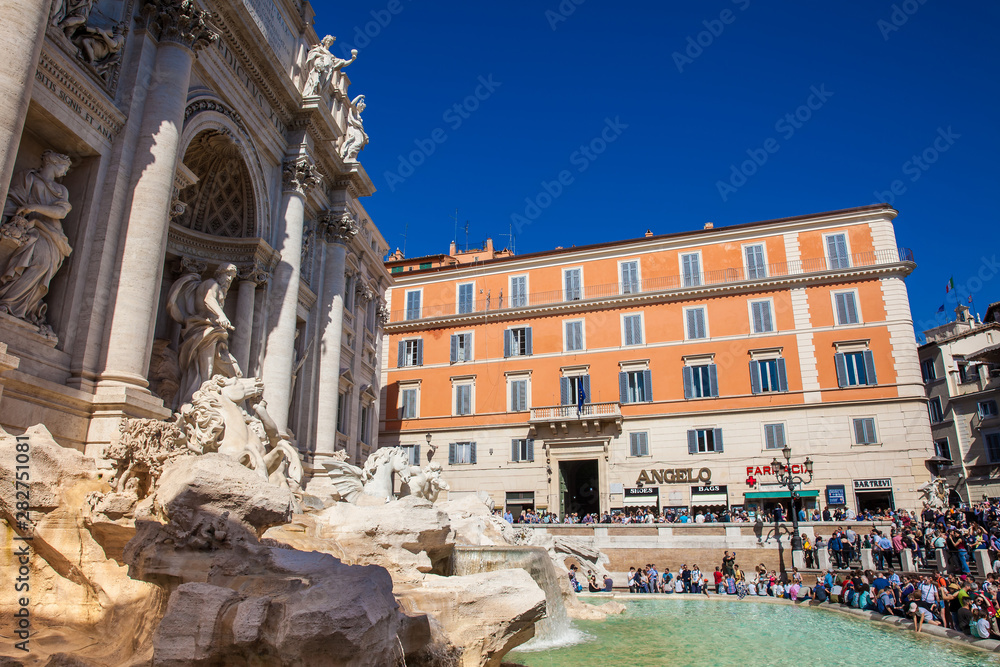 Tourists at the Trevi Fountain designed by Italian architect Nicola Salvi and completed by Giuseppe Pannini  in 1762