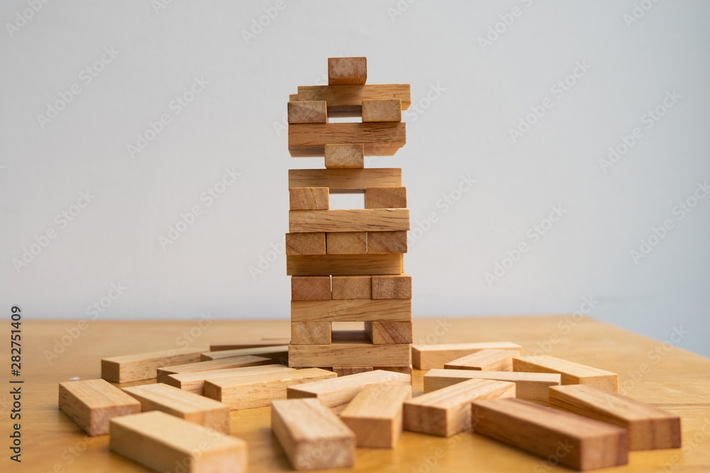 Wood block tower with architecture model, Concept Risk of management and strategy plan, growth business success process and team work Wood block tower with architecture model, Concept Risk of management and strategy plan, growth business success process and team work