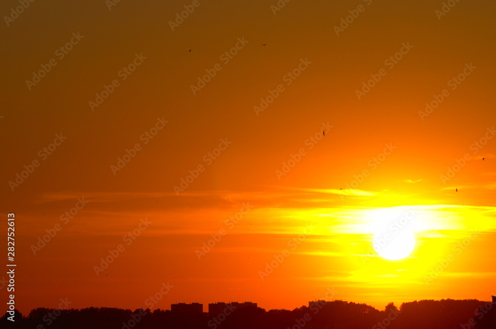 Sunny sunset over the city, sun burst. Vitebsk, Belarus, June 2019