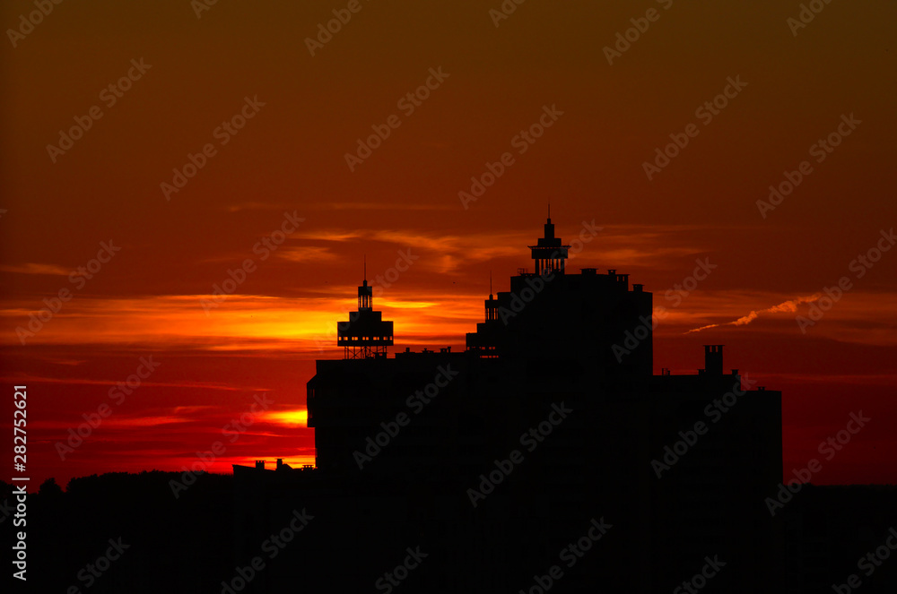 Sunset over the city, sun beyond horizon, building silhouette. Vitebsk, Belarus, June 2019