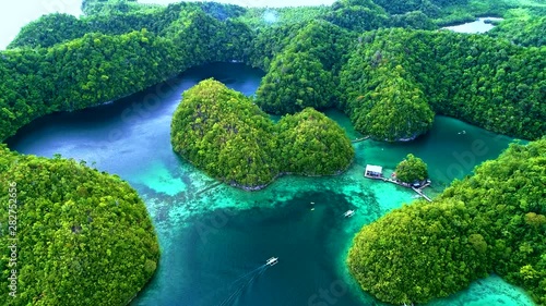 Tropical landscape rainforest hills and azure water in lagoon with clouds on the Siargao island, Philippines. Drone Aerial view 4Kl