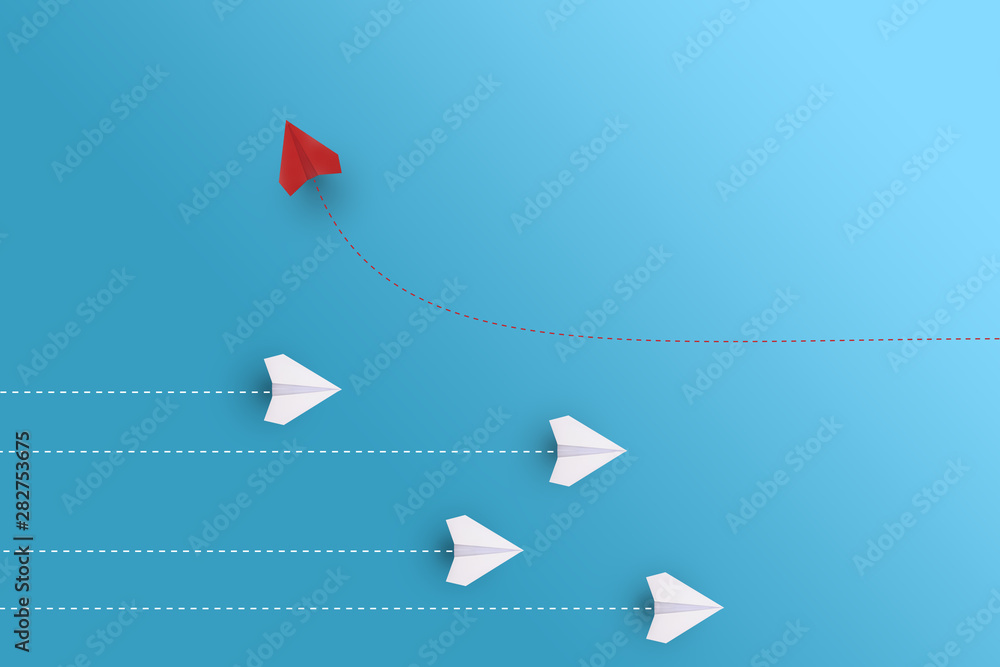 Creative paper planes on blue background. Leadership and success concept.group of white paper planes in one direction and one red paper plane pointing in different way. - obrazy, fototapety, plakaty 