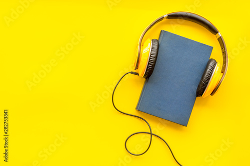 workplace with books and headphones on yellow background flatlay mockup