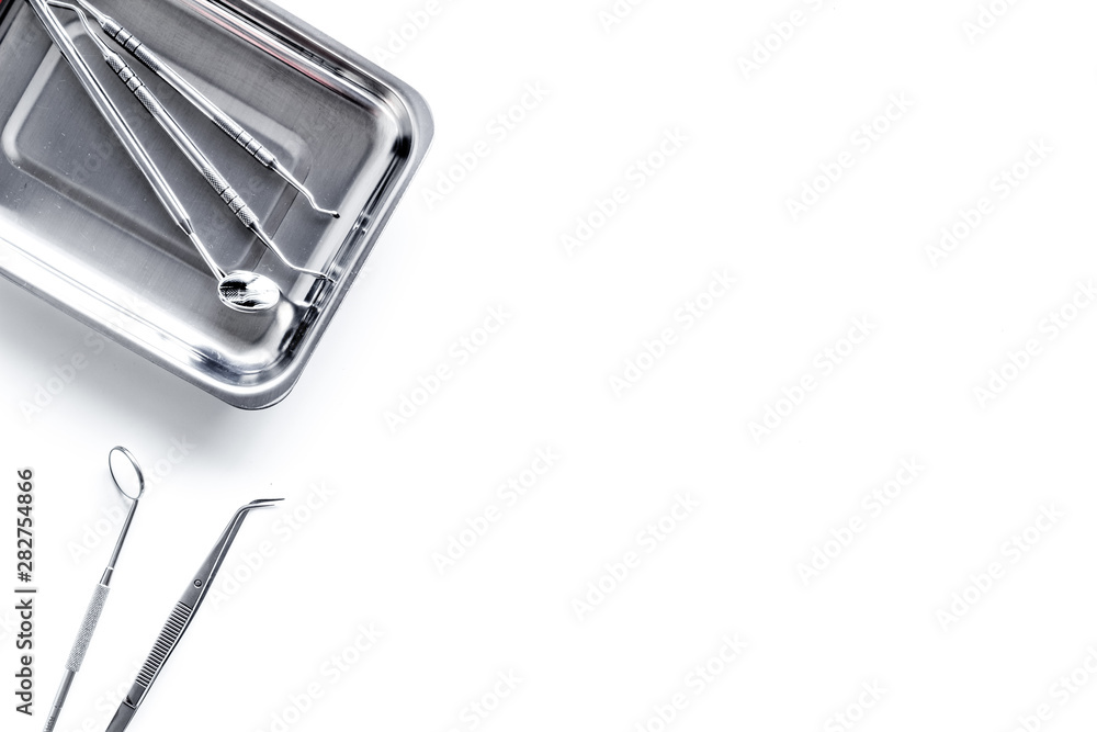 Dentist work desk with tools for teeth on white background top view mock up Dentist work desk with tools for teeth on white background top view mock up