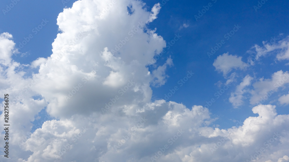 Obraz premium Beautiful bright blue sky with white fluffy clouds on a clear sunny day. Royalty high-quality free stock photo image of blue sky with white cloud, nice weather. Photo of natural cloudscape background