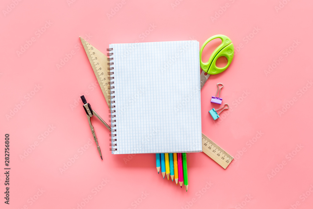 Back to school with stationary, notebook and scissors on pink student desk background top view mockup Back to school with stationary, notebook and scissors on pink student desk background top view mockup