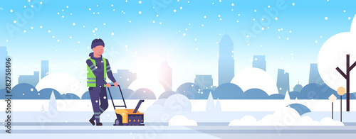 man worker in uniform using snowblower snow removal winter street cleaning service concept cleaner pushing snow thrower modern cityscape sunrise background flat full length