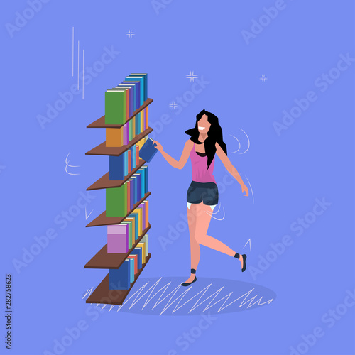 woman standing near bookshelf smiling girl choosing books for reading library or bookstore visitor flat full length