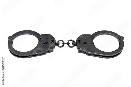 Black handcuffs isolated on the white background.