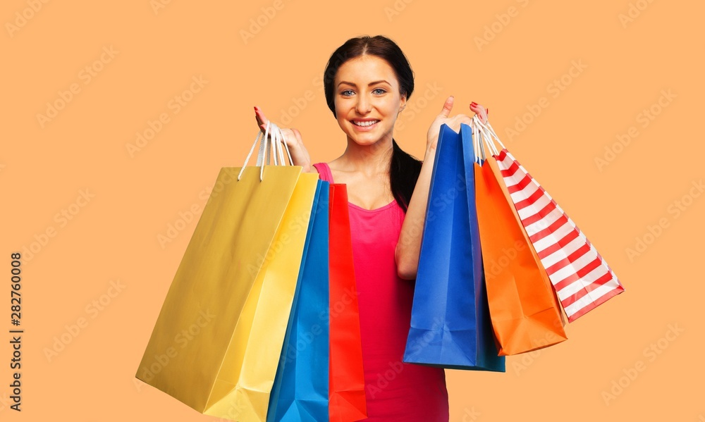 Young woman with shopping bags on  background