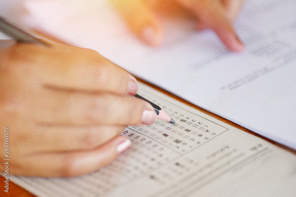 take the exam final high school hand student holding pencil writing on paper answer sheet - education college in class taking notes sitting learning writing selected choice in examination room take the exam final high school hand student holding pencil writing on paper answer sheet - education college in class taking notes sitting learning writing selected choice in examination room