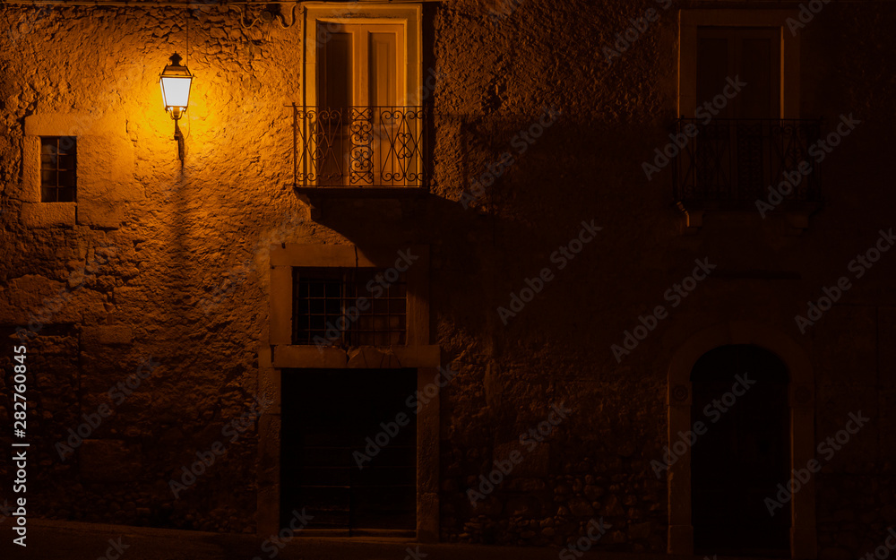 Italian medieval street lit at night