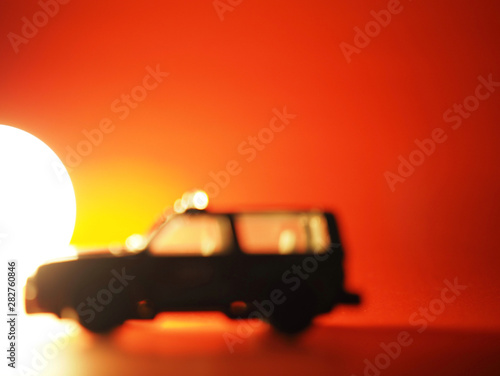Blurred illustration of a car in sunset