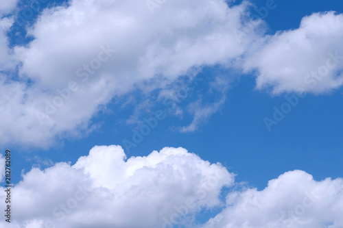 Background of blue sky with white fluffy clouds. Cropped shot  horizontal  outdoors  nobody. Concept of nature and ecology.