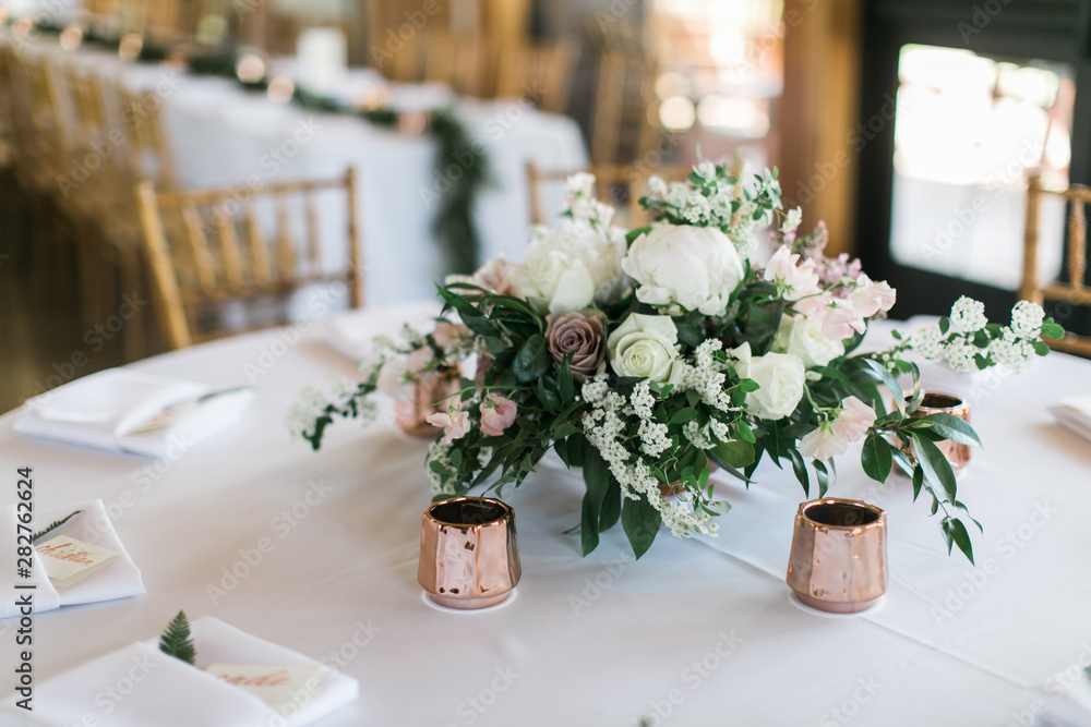 Modern wedding flowers on table, rose gold candle holders, reception table decoration, white, pink, and green flowers Modern wedding flowers on table, rose gold candle holders, reception table decoration, white, pink, and green flowers