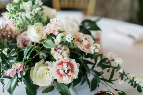 Close up of modern wedding flowers on table  reception table decoration  white  pink  and green flowers