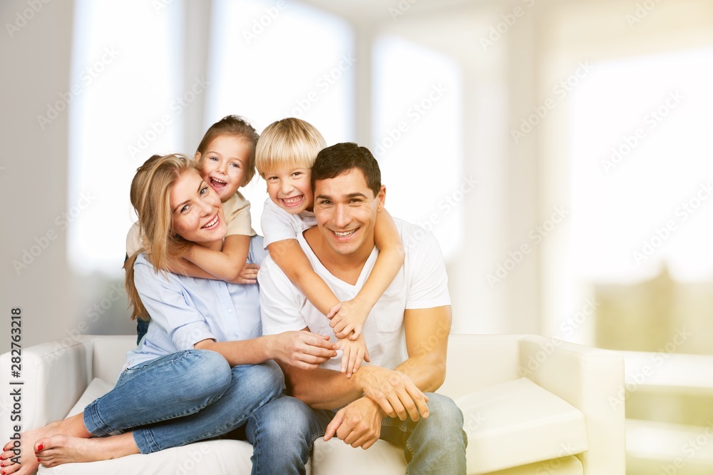 Young family at home smiling at camera Young family at home smiling at camera