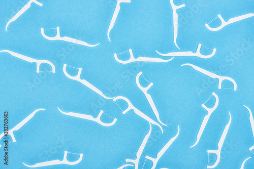 top view of white floss sticks isolated on blue