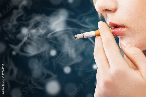 Portrait of the beautiful elegant girl smoking cigarette isolated