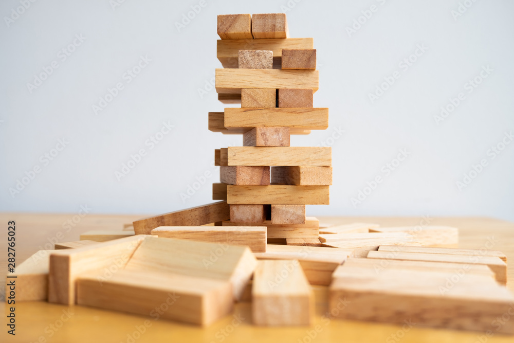 Wood block tower with architecture model, Concept Risk of management and strategy plan, growth business success process and team work Wood block tower with architecture model, Concept Risk of management and strategy plan, growth business success process and team work