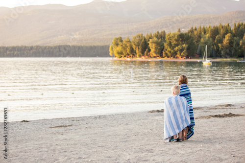 Young boy and girl looking off into distance at Whitefish Lake in Montana