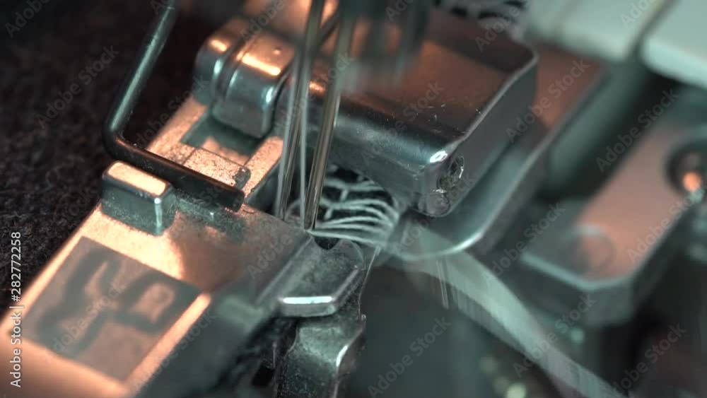 A Serger or Overlocking Sewing Machine. Presser foot close up A Serger or Overlocking Sewing Machine. Presser foot close up