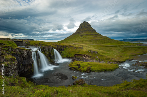 Kirkjufellsfoss waterfall and Kirkjufell mountain  Iceland