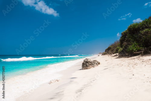 Tropical beach with white sand  blue ocean and waves