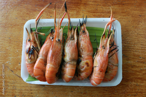close up grilled giant river prawn plate on wooden table
