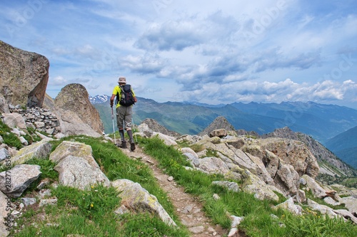 Senior man hiking in Dolomites with remote mountains in the background