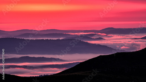 Mountains' silhouettes and pink sky. Awesome sunrise in Bieszczady Mountains. Poland