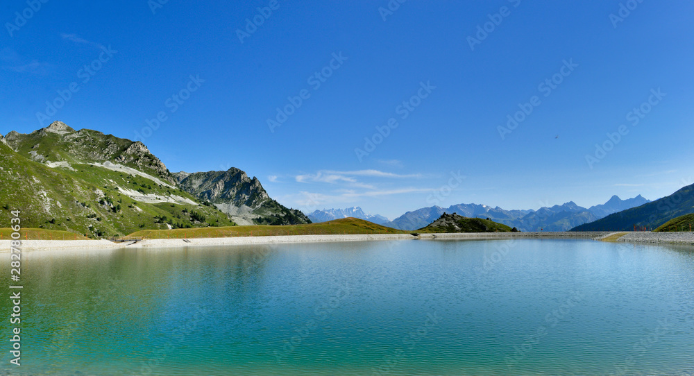 view on a beautiful lake in mountain under blue sky in a natural alpine European Park