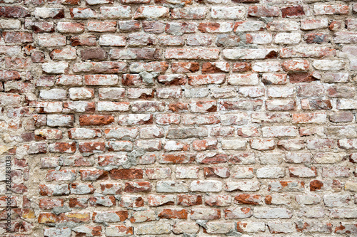 Ancient grey brick wall background texture.