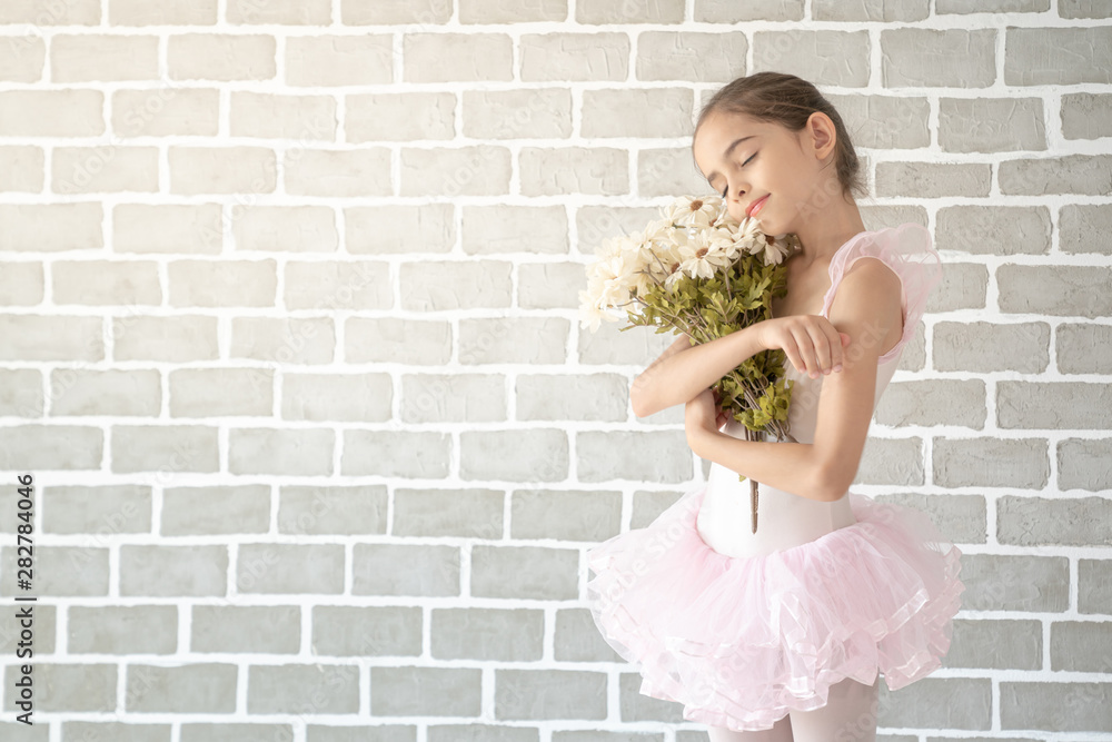 Cute little young preschool girl ballerina dance in pink leotard and