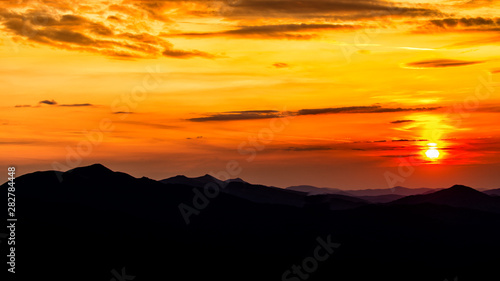 Fototapeta Naklejka Na Ścianę i Meble -  Stunning sunset in the mountains. Orange sky and mountains silhouettes. Carpathian Mountains. Bieszczady. Poland
