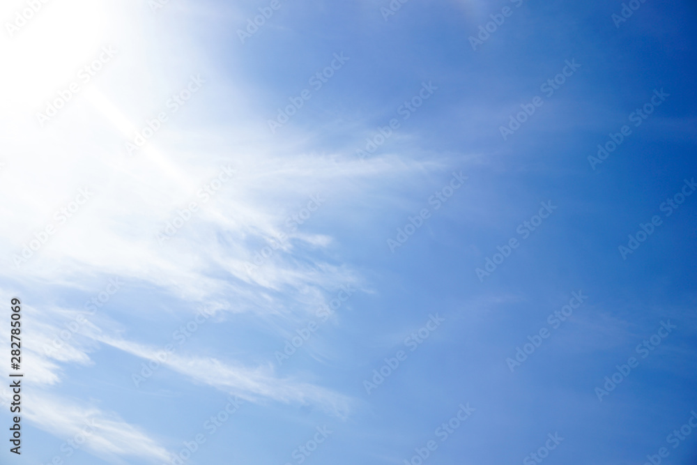 Clear blue sky and white cloud with sunlight from the sun,nature background in sunshine day Clear blue sky and white cloud with sunlight from the sun,nature background in sunshine day