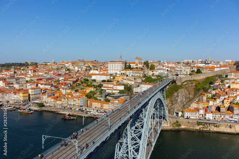 Porto, Portugal - 10/20/2019: Famous Porto bridge Ponte Luis top view. Porto bridge over river Douro. Portuguese river Douro with metro bridge and tourists. Porto landmark on sunny day. Summer travel.