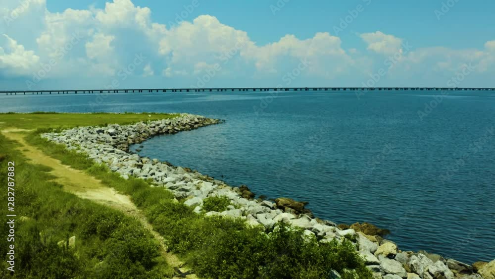 A bright, sunny day out on the lakefront. Looking out over a large lake from the shoreline. A bright, sunny day out on the lakefront. Looking out over a large lake from the shoreline.