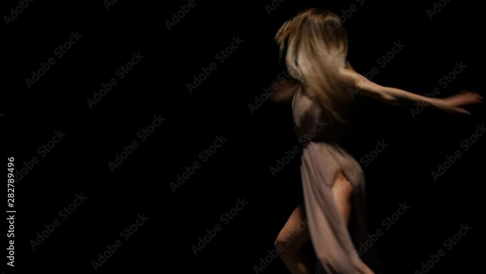 Talented lady performing contemp in dark studio at spotlight. Slow motion Talented lady performing contemp in dark studio at spotlight. Slow motion